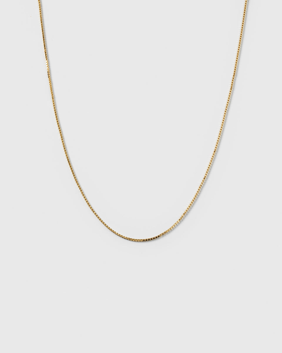 A product shot of the Beloved Short Box Chain Gold, a delicate gold necklace with a box chain design.