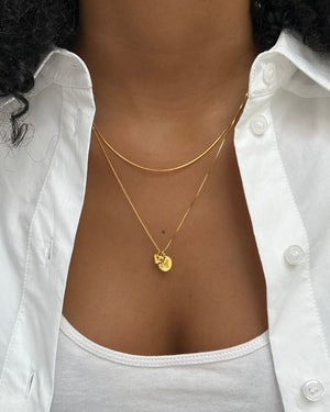 Silver heart pendant necklace paired with a unique, beautiful necklace..