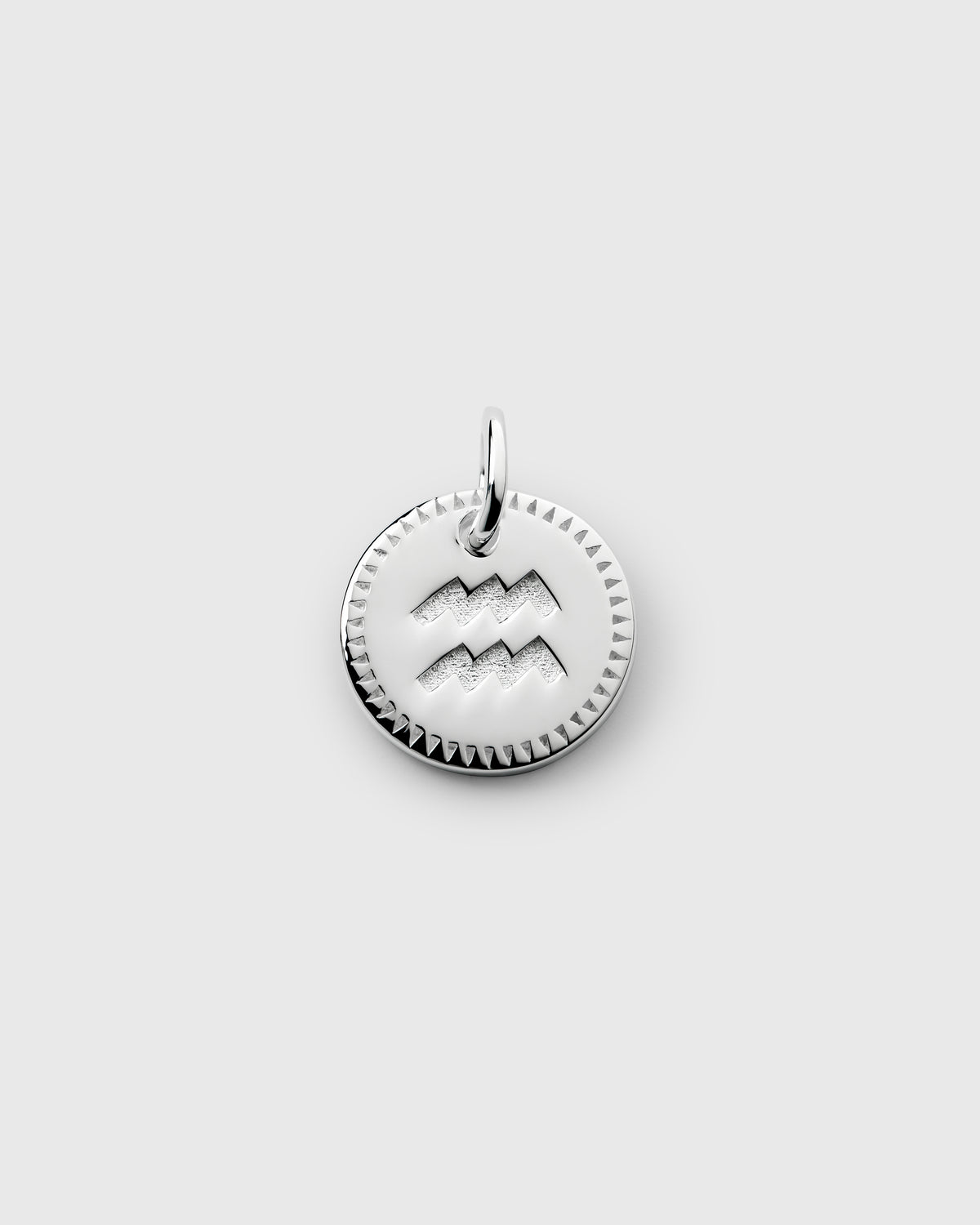 A product shot of the Beloved Zodie Pendant in silver, featuring the Aquarius sign engraved on a circular charm with a decorative triangular border.