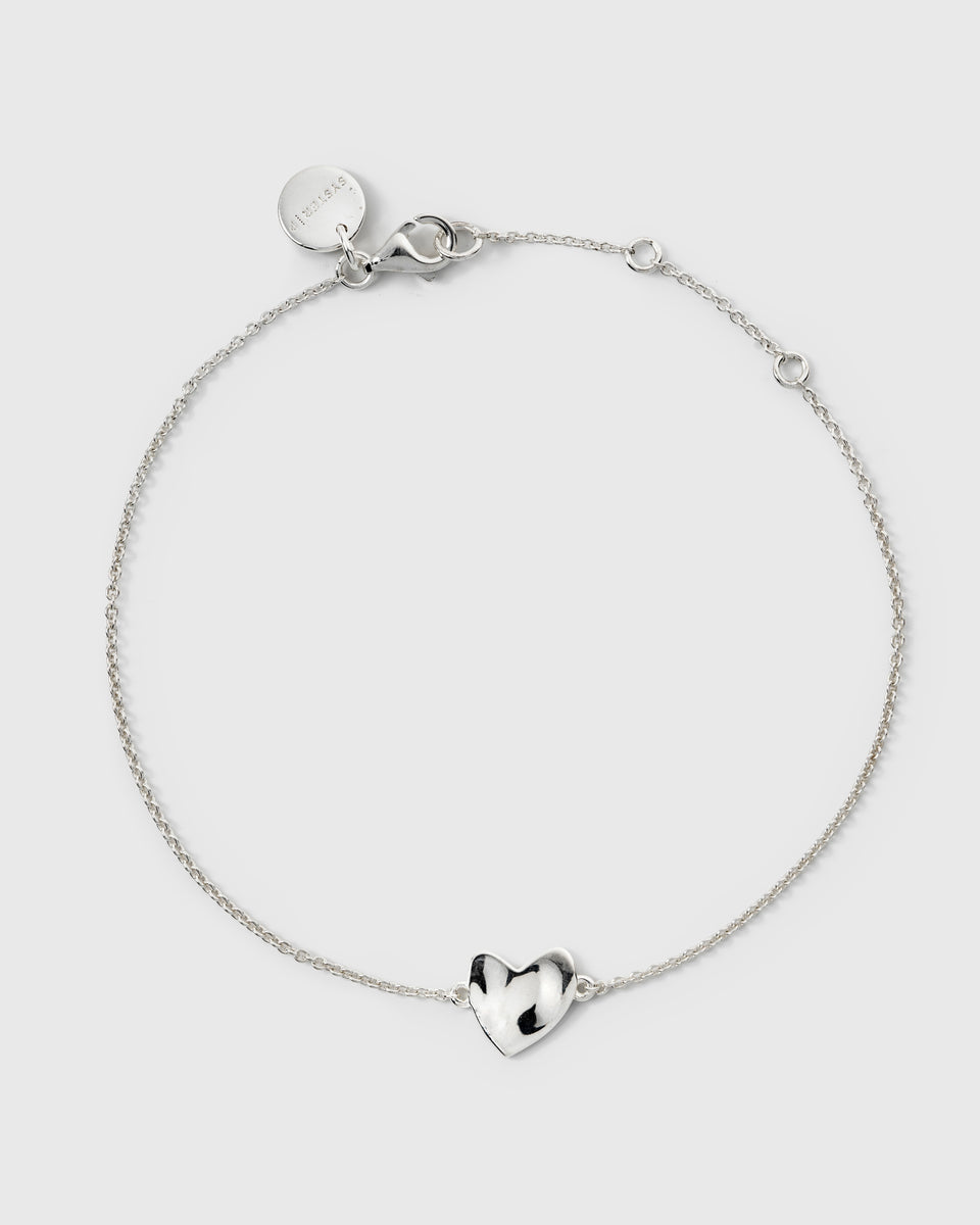 Delicate silver chain bracelet featuring a hammered heart charm.