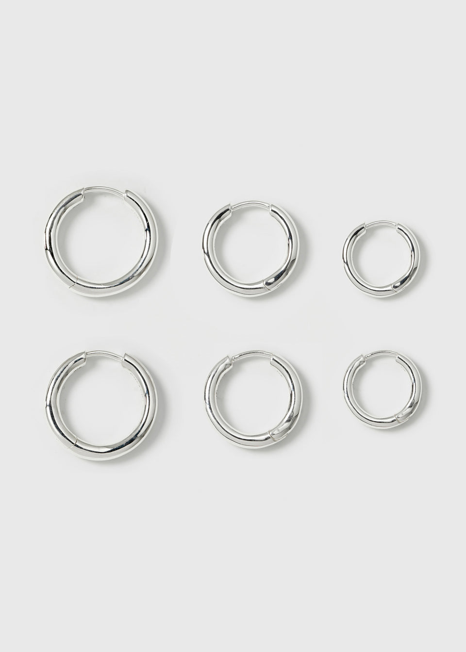A product shot of the Beloved Fat Hoops Set in silver, displaying the three pairs of chunky hoop earrings in small, medium, and large sizes.