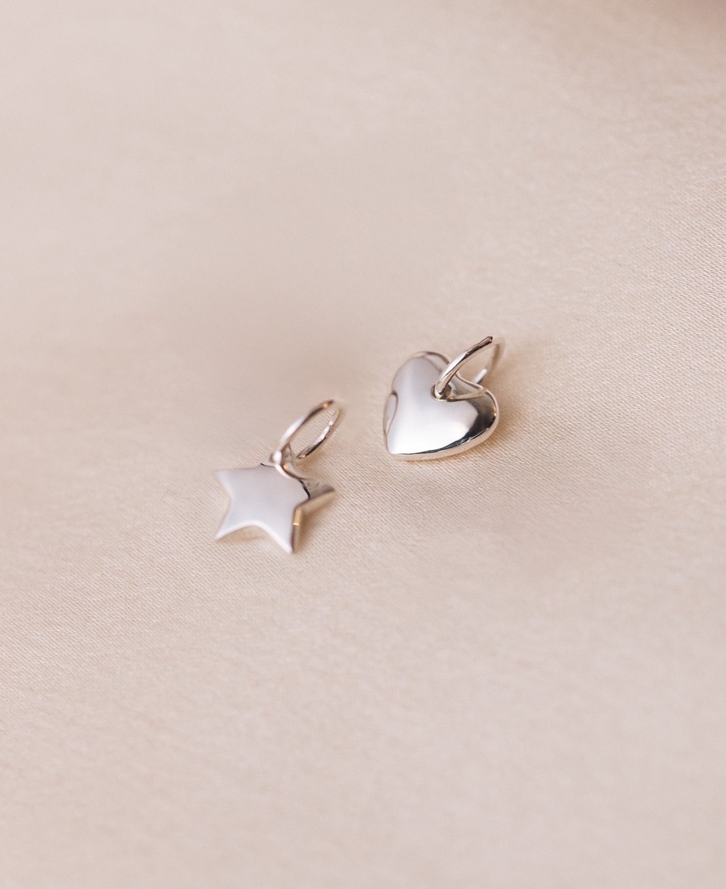 A product shot of the Beloved Star Pendant in silver, shown alongside the matching Beloved Heart Pendant.