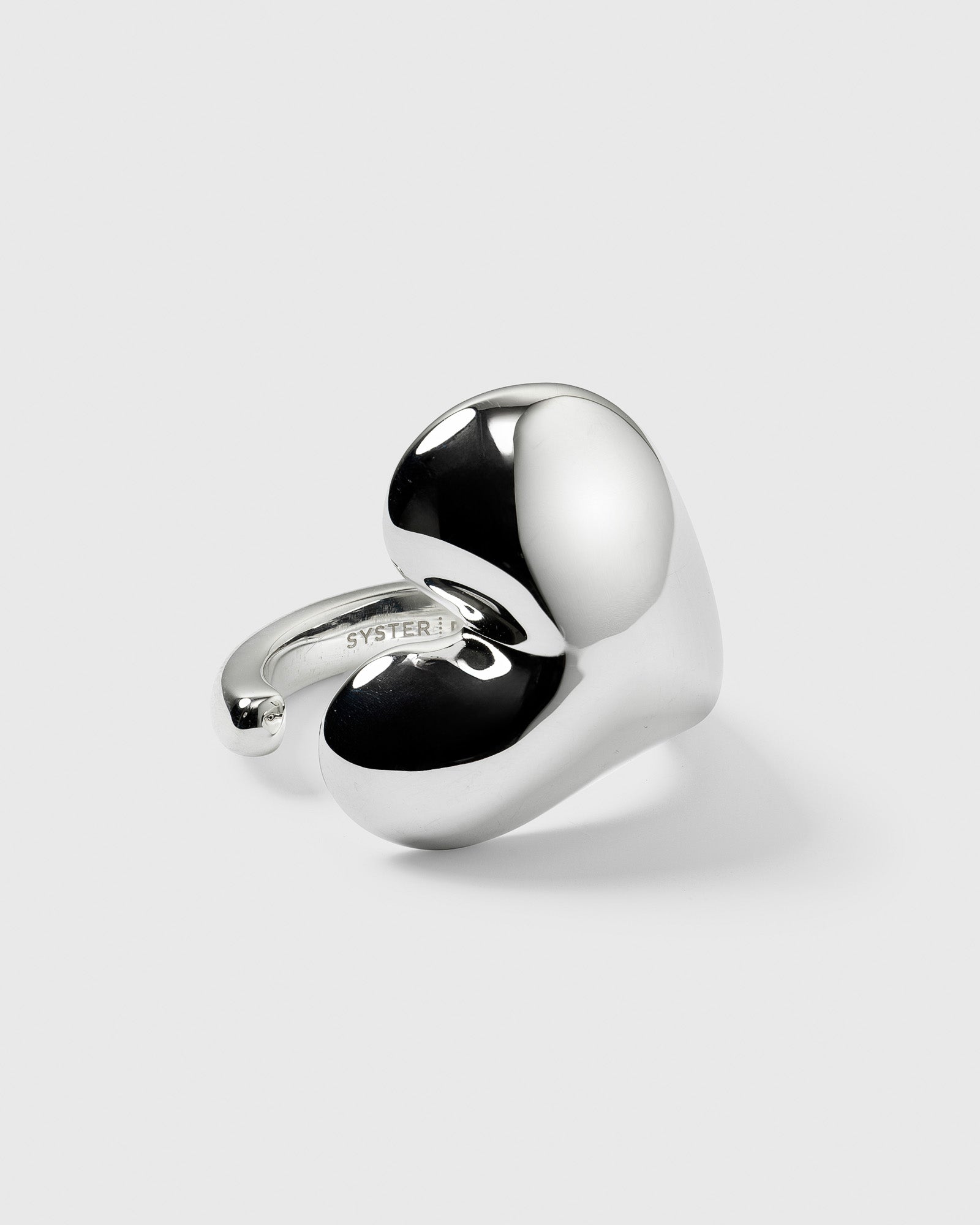 A product shot of the Bolded Heart Ring in silver, showcasing its large, polished, heart-shaped design.