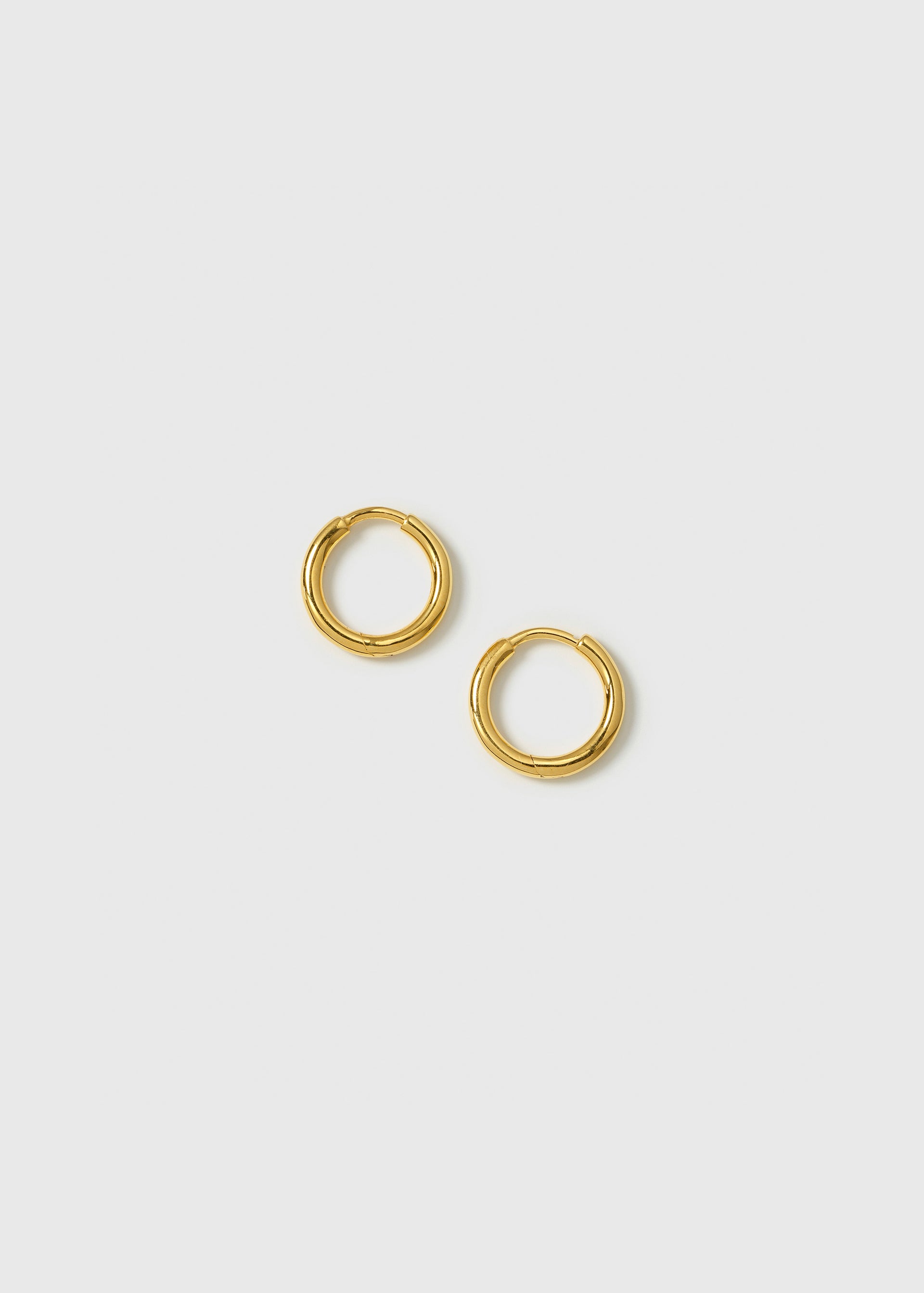 A product shot of the Beloved Fat Small Hoops Gold, highlighting their classic and thick circular design.
