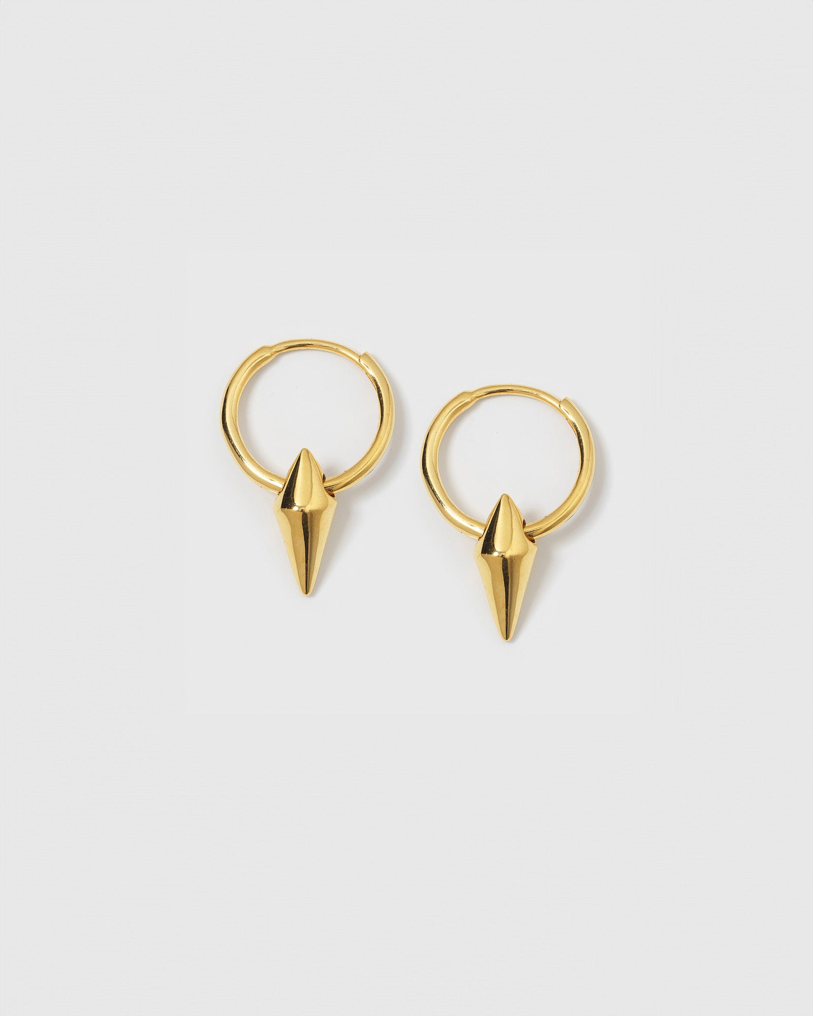 A product shot of the Harvey Small Spike Hoops in gold, featuring a pair of small hoops each adorned with a pointed spike charm.