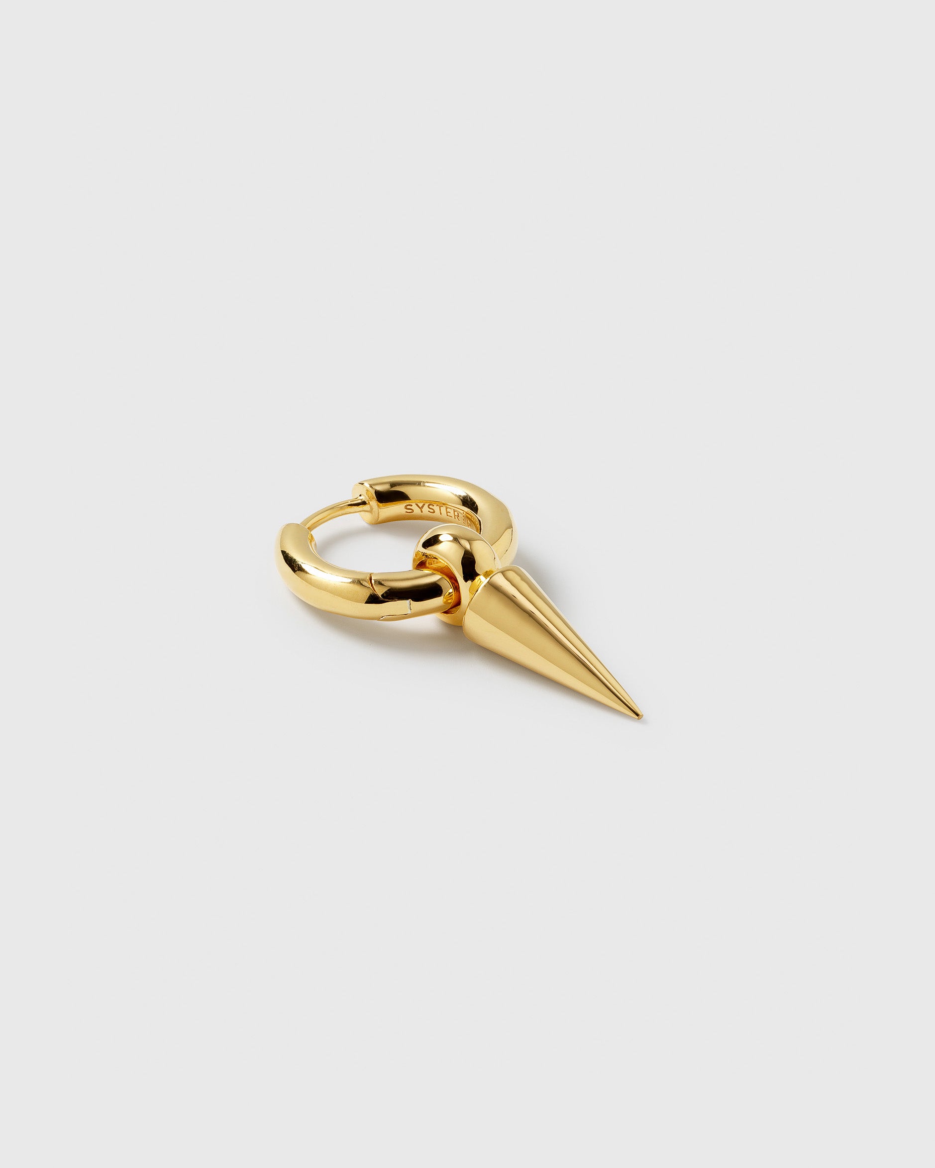 A product shot of the Juno Single Hoop in gold, showing the chunky hoop with a dangling spike charm.