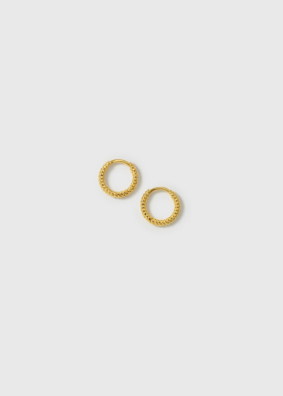 A product shot of the Beloved Twisted Small Hoops in gold, showcasing their detailed twisted design.