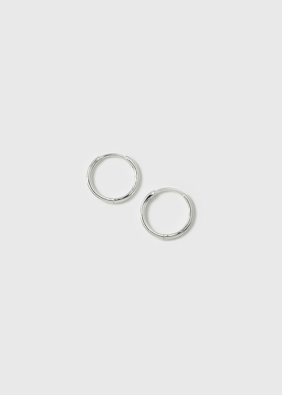 A product shot of the Beloved Small Hoops in silver, showcasing the pair of classic, small hoop earrings.