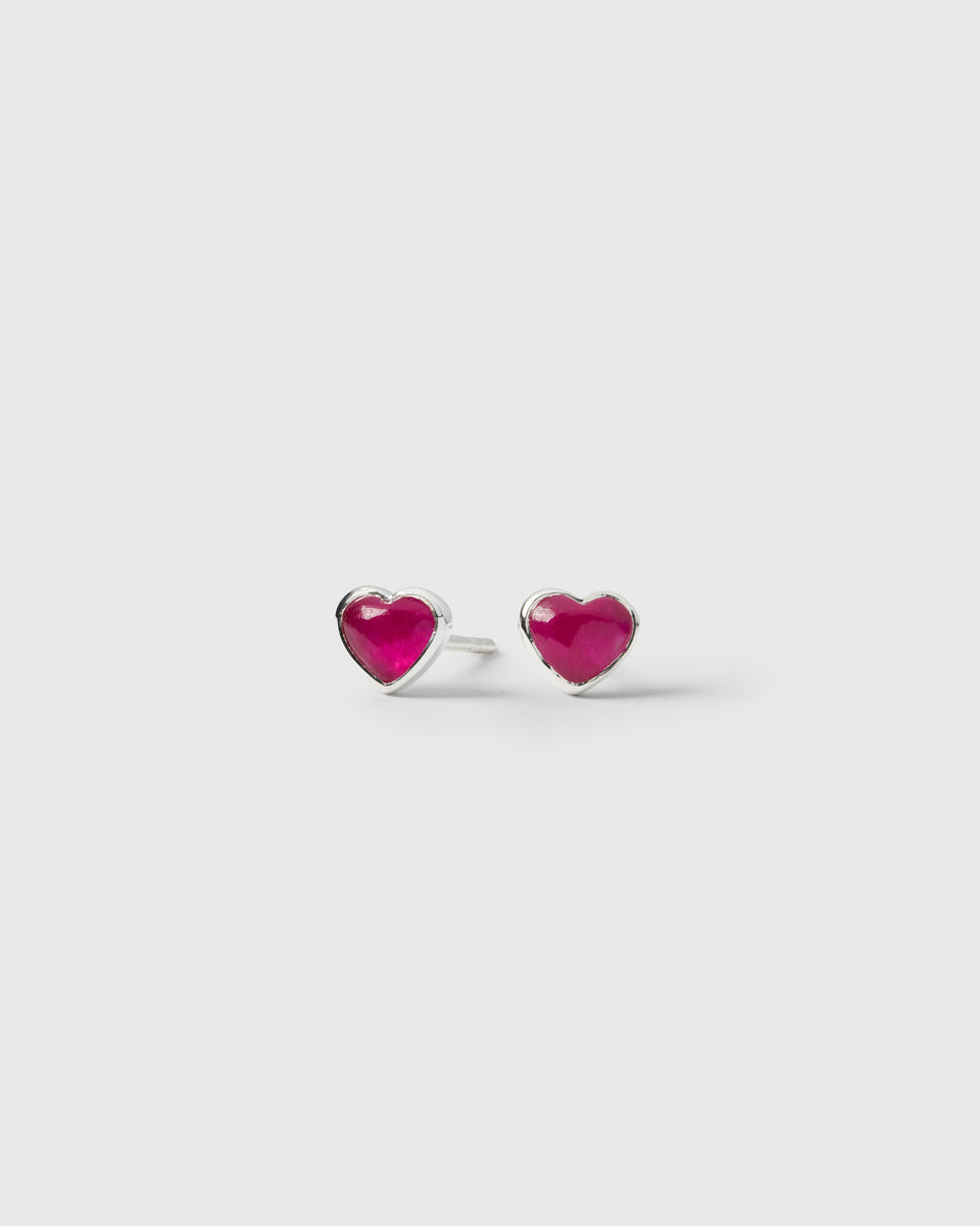 A pair of La La Love stud earrings in silver, a heart-shaped design featuring a pink quartz stone set in sterling silver.