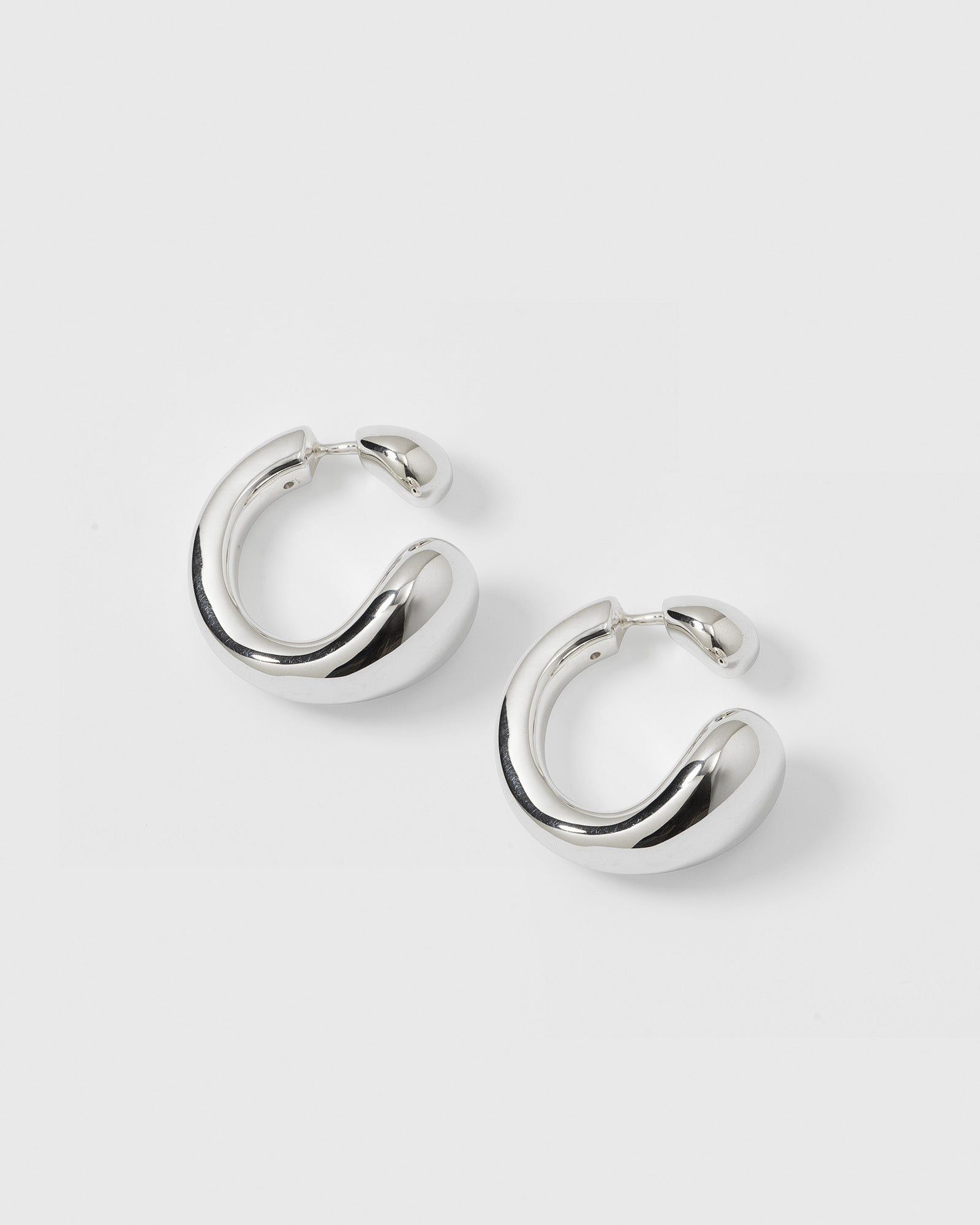 A product shot of the Bolded Drops Earrings in silver, showcasing their unique, bold, and drop-inspired shape.