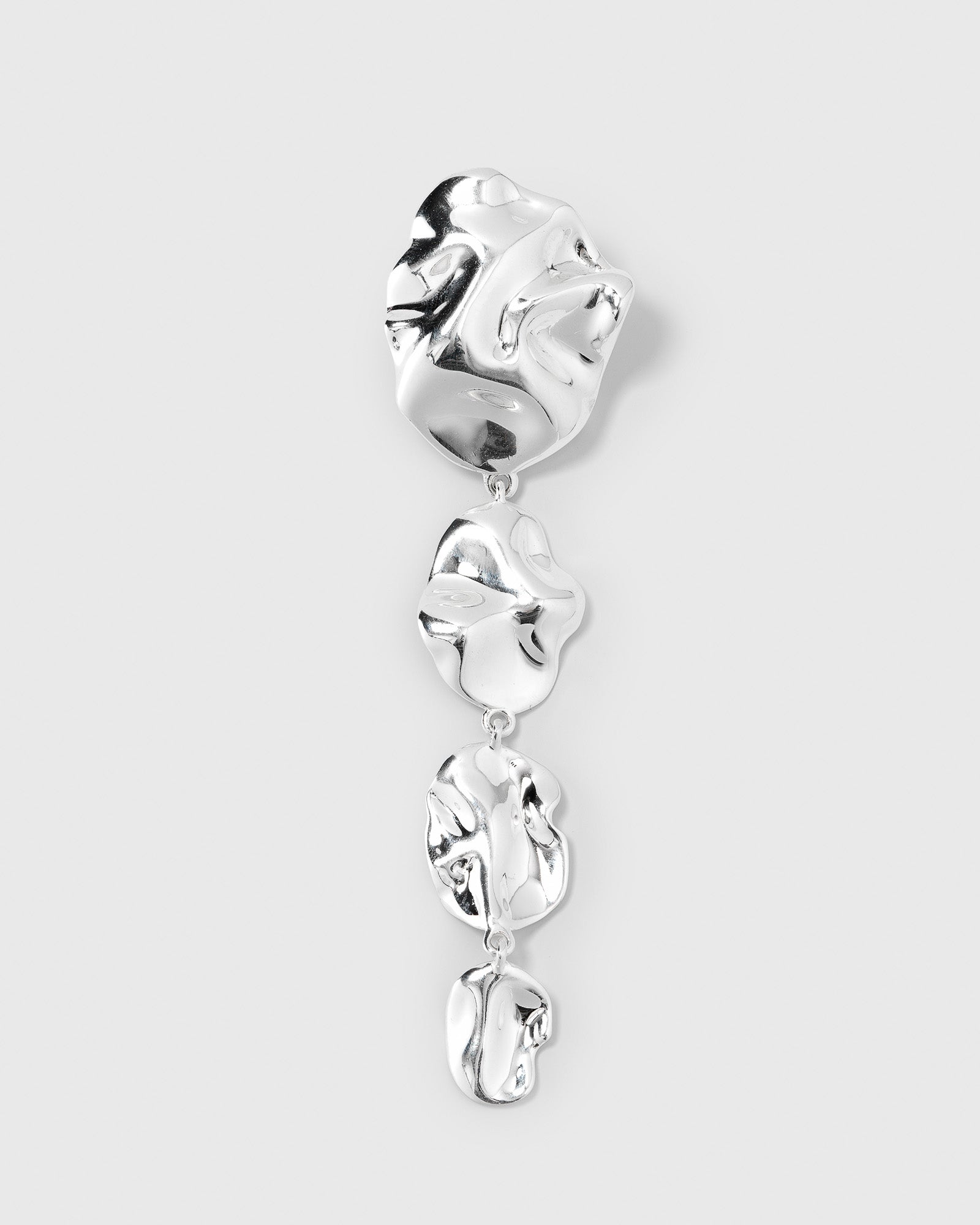 A product shot of the Moulded Long Single Earring in silver, showcasing its long, dangling design made up of four interconnected, organically shaped pieces with a reflective, moulded surface.