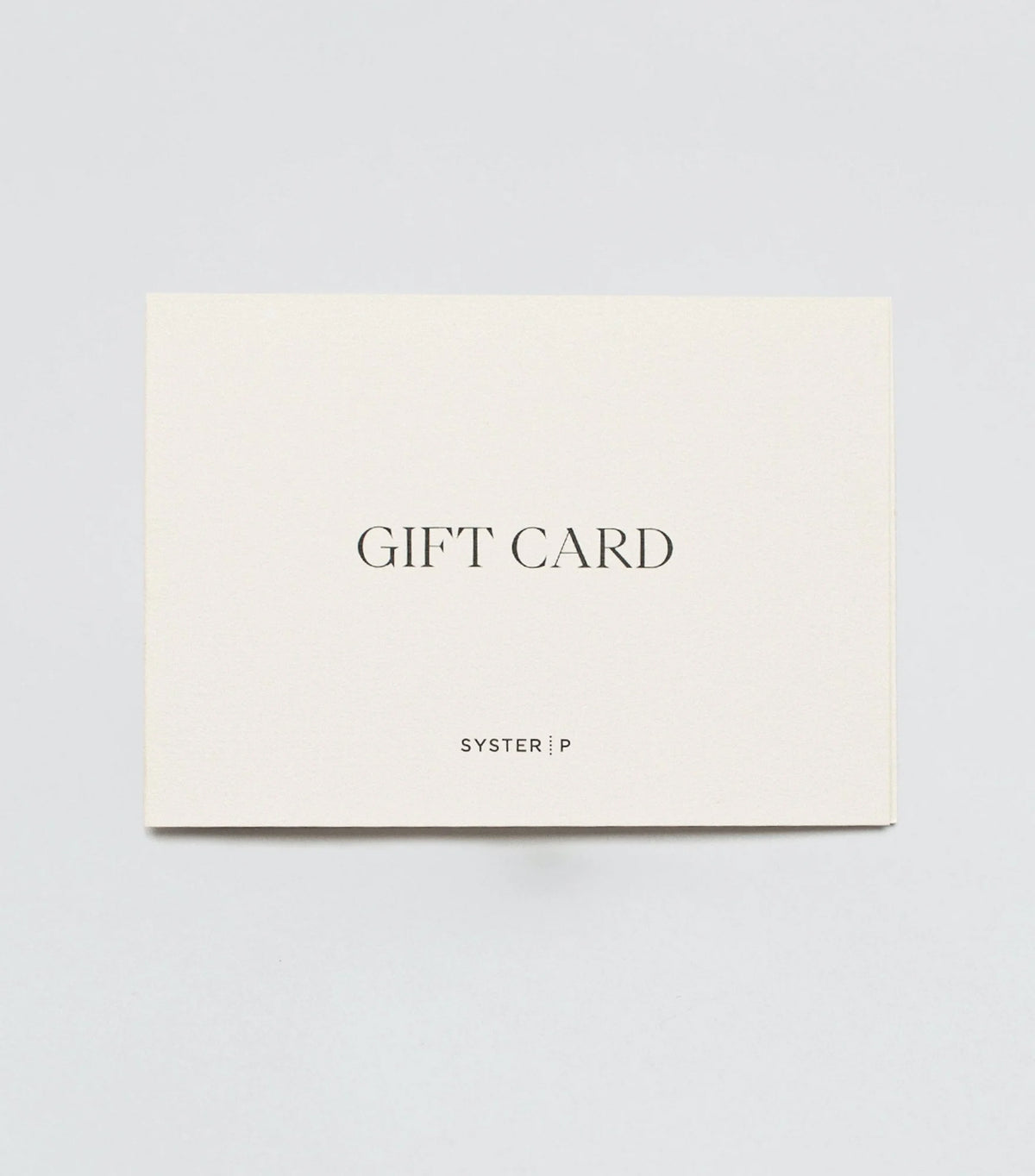 A product shot of the Syster P Gift Card, an off-white rectangular card with 'GIFT CARD' and the Syster P logo printed in black.