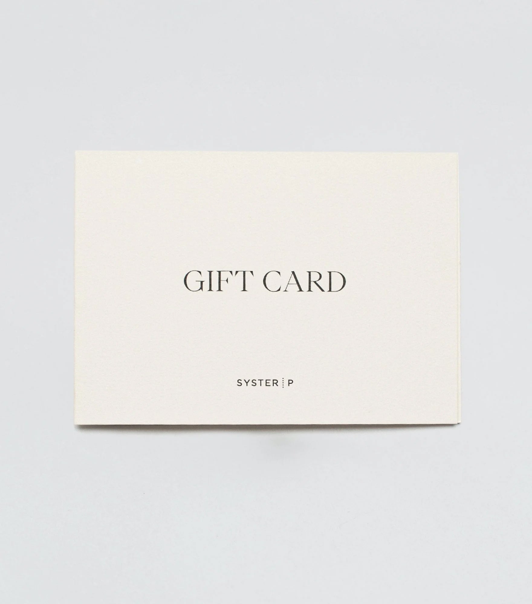 A product shot of the Syster P gift card, a cream-colored card with "GIFT CARD" and the Syster P logo printed on the front.