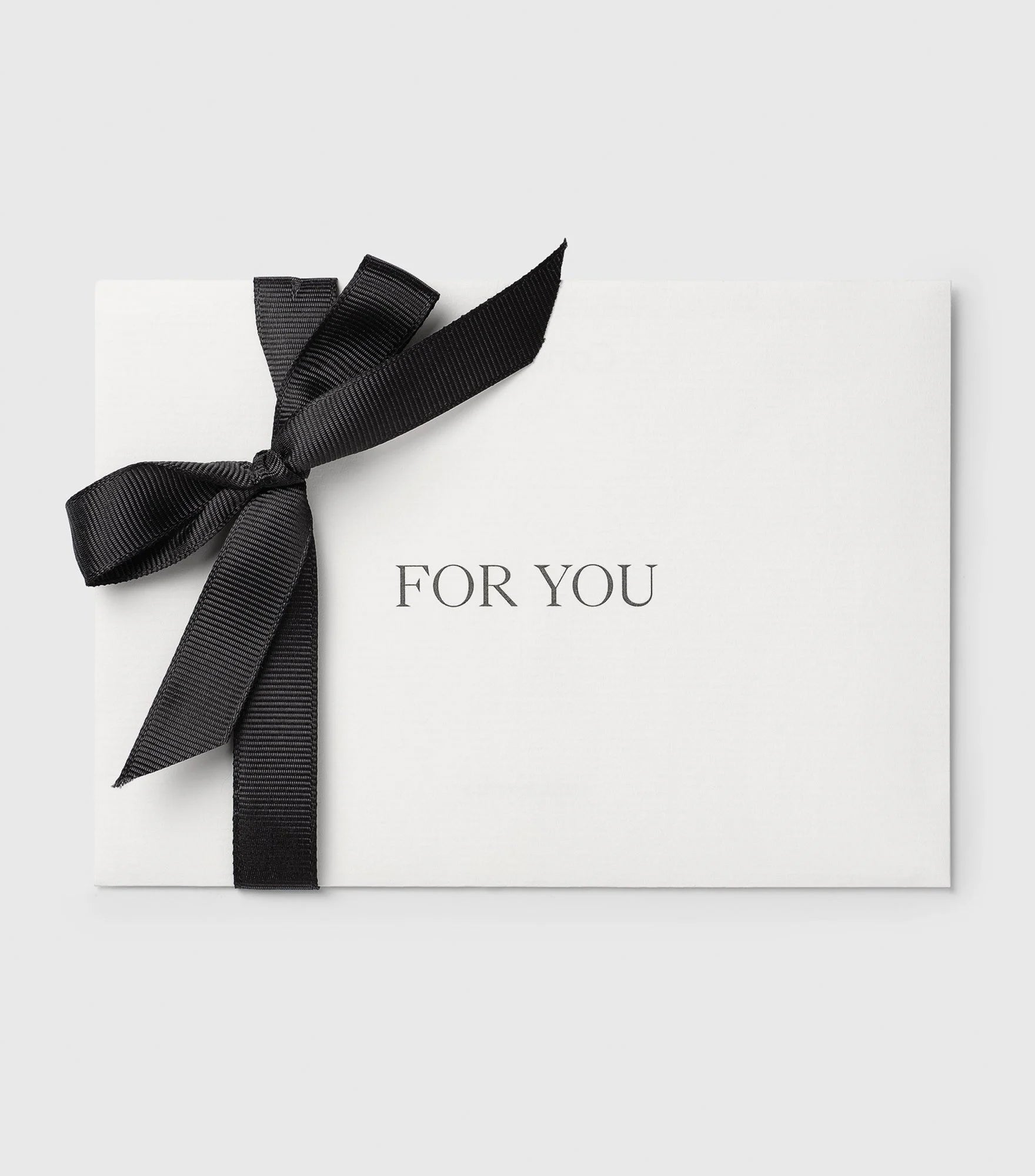 A product image of the Syster P Gift Card, presented in a white envelope tied with a black grosgrain ribbon in a bow, with the text 'FOR YOU' printed in the center.
