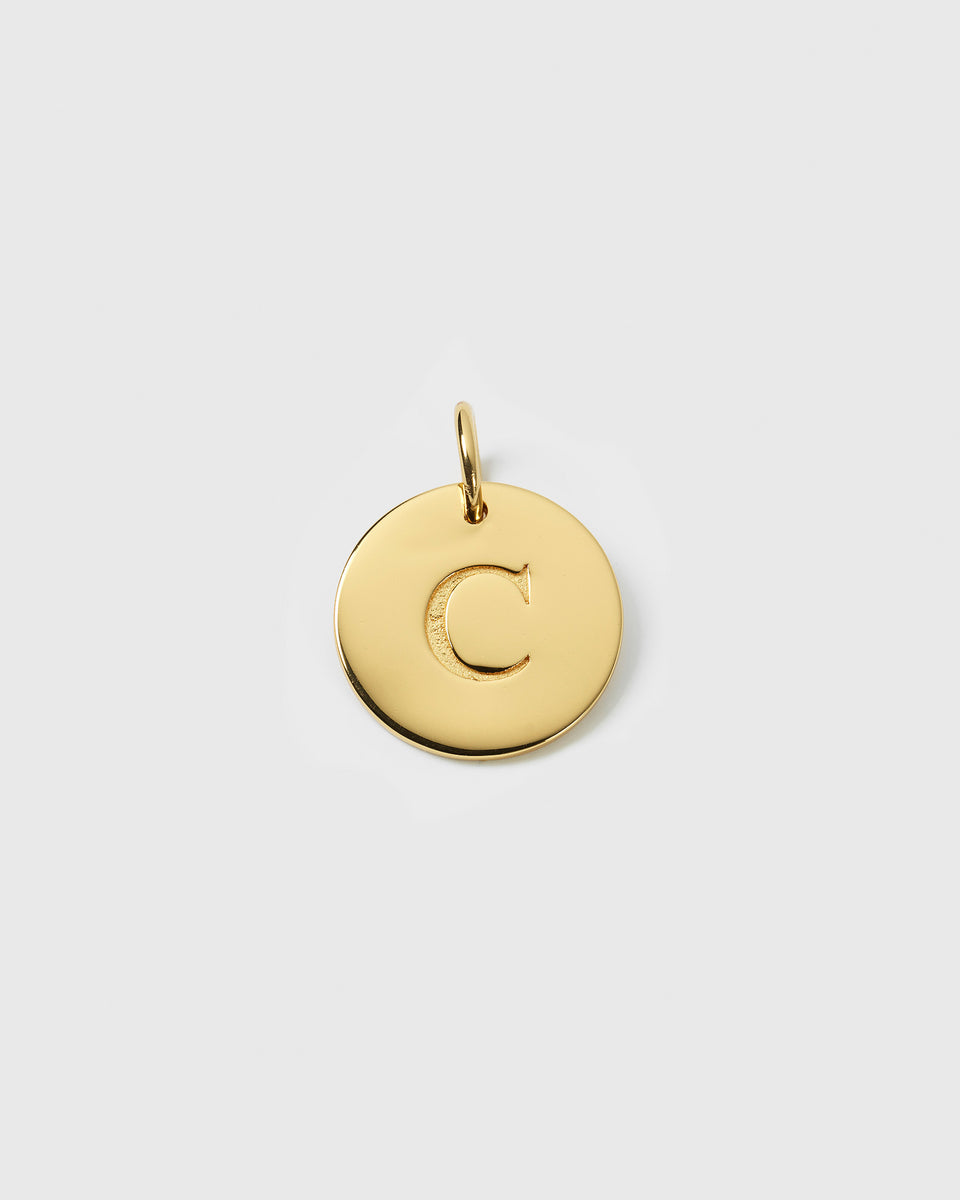 A product shot of the Beloved Big Letter charm in gold, featuring a round pendant with the letter 'C' engraved on its surface.