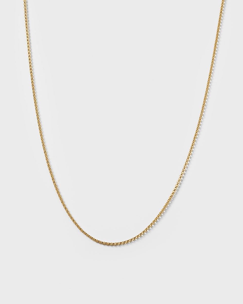 A product shot of the Beloved Medium Rolo Chain in gold, displayed in a soft curve to highlight its delicate rolo link design.