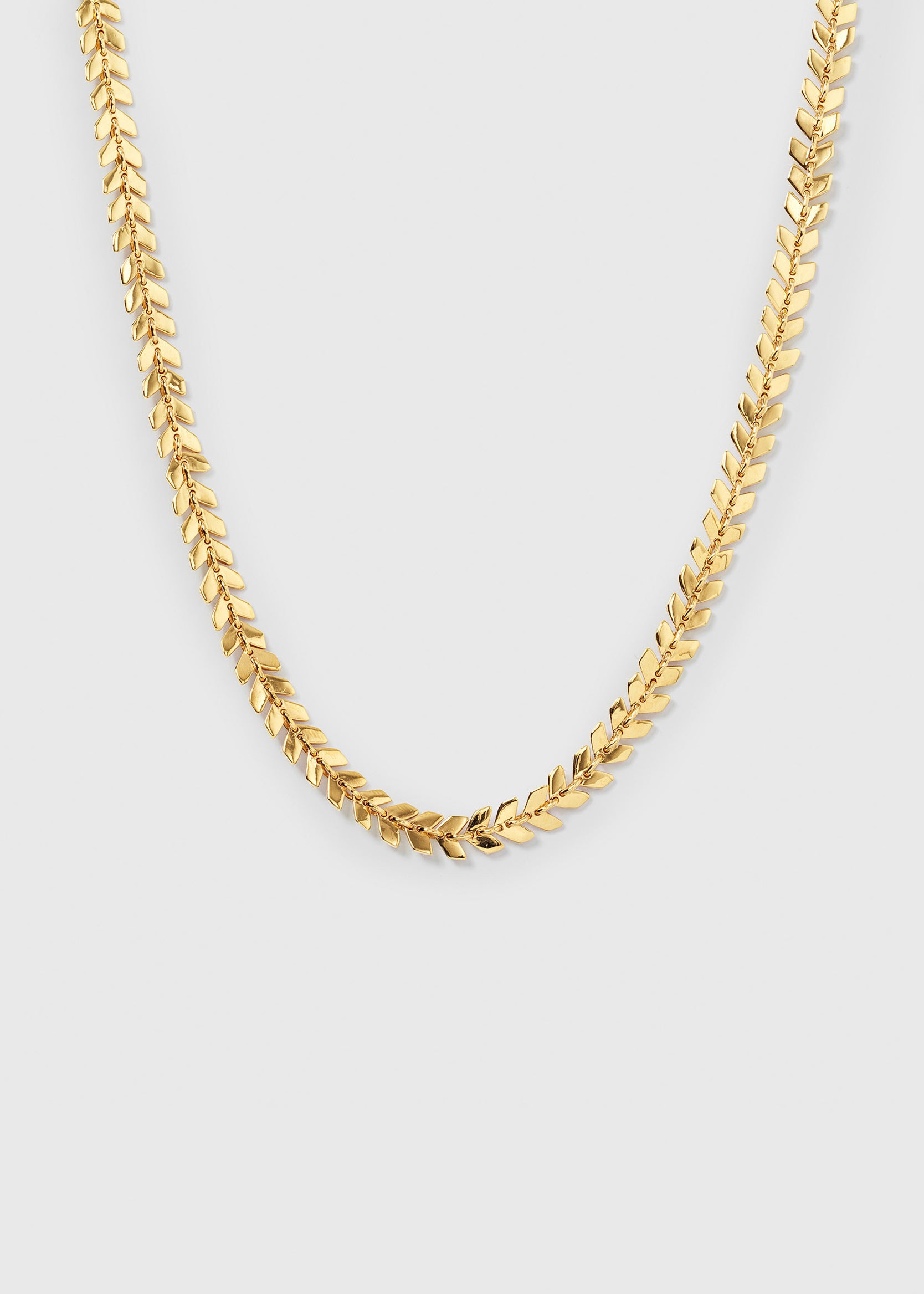 A product shot of the Layers Olivia Necklace in gold, laid out to display its beautiful pattern of small, leaf-like links.