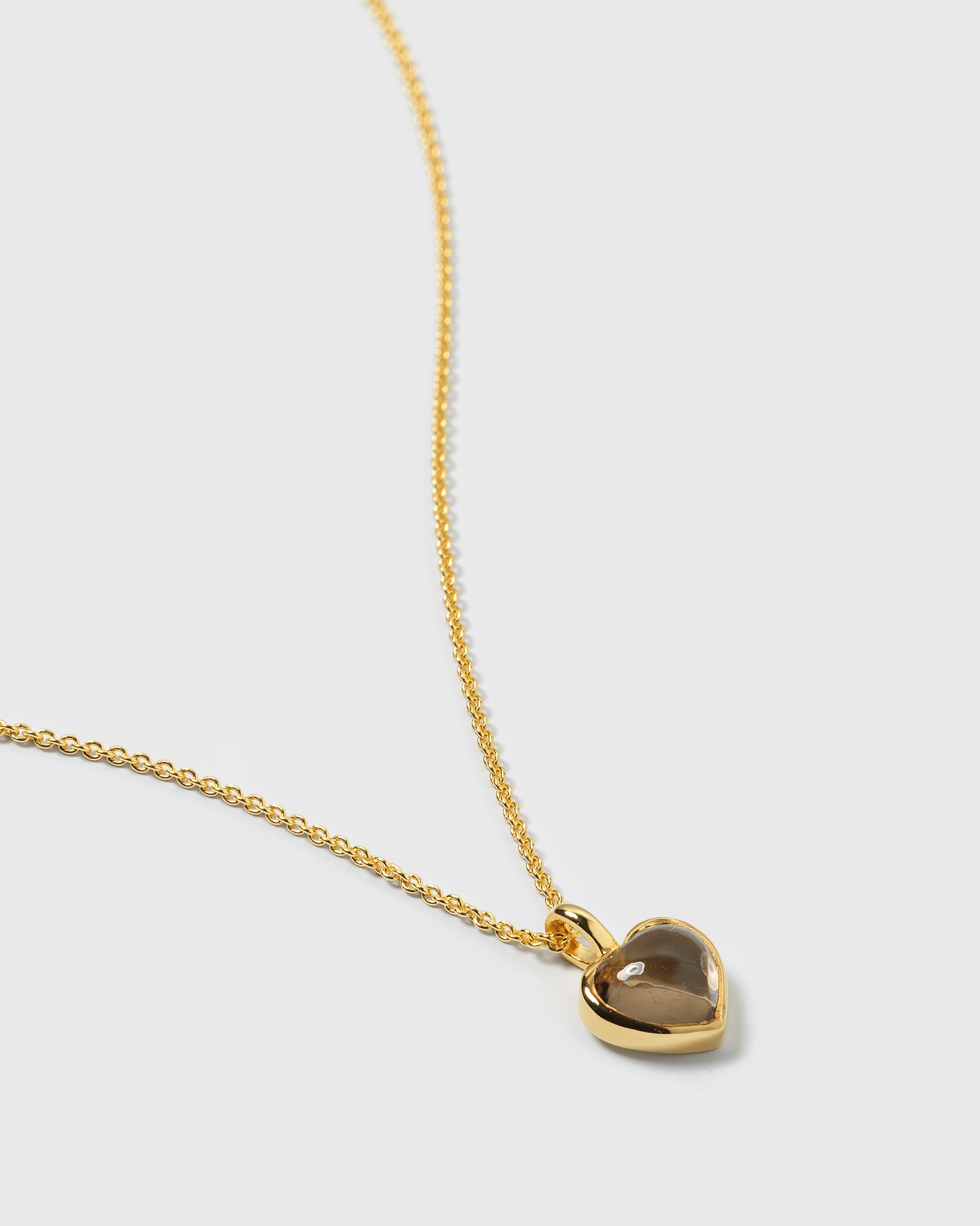 Close-up of the La La Love Necklace, highlighting its gold-plated chain and smokey quartz heart pendant.