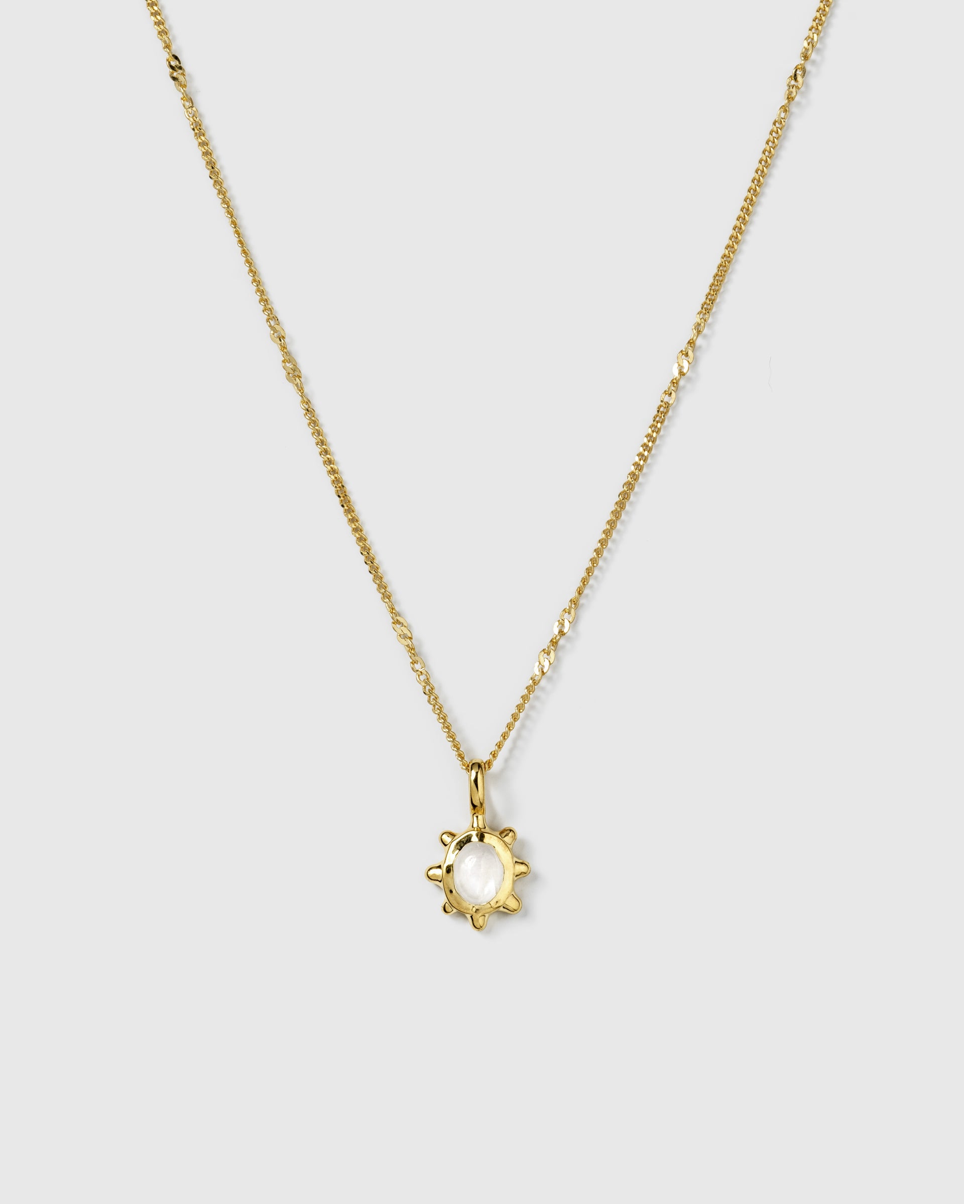 A product shot of the Florentina Necklace in gold, featuring a flower-shaped pendant with a central moonstone on a delicate, twisted chain.