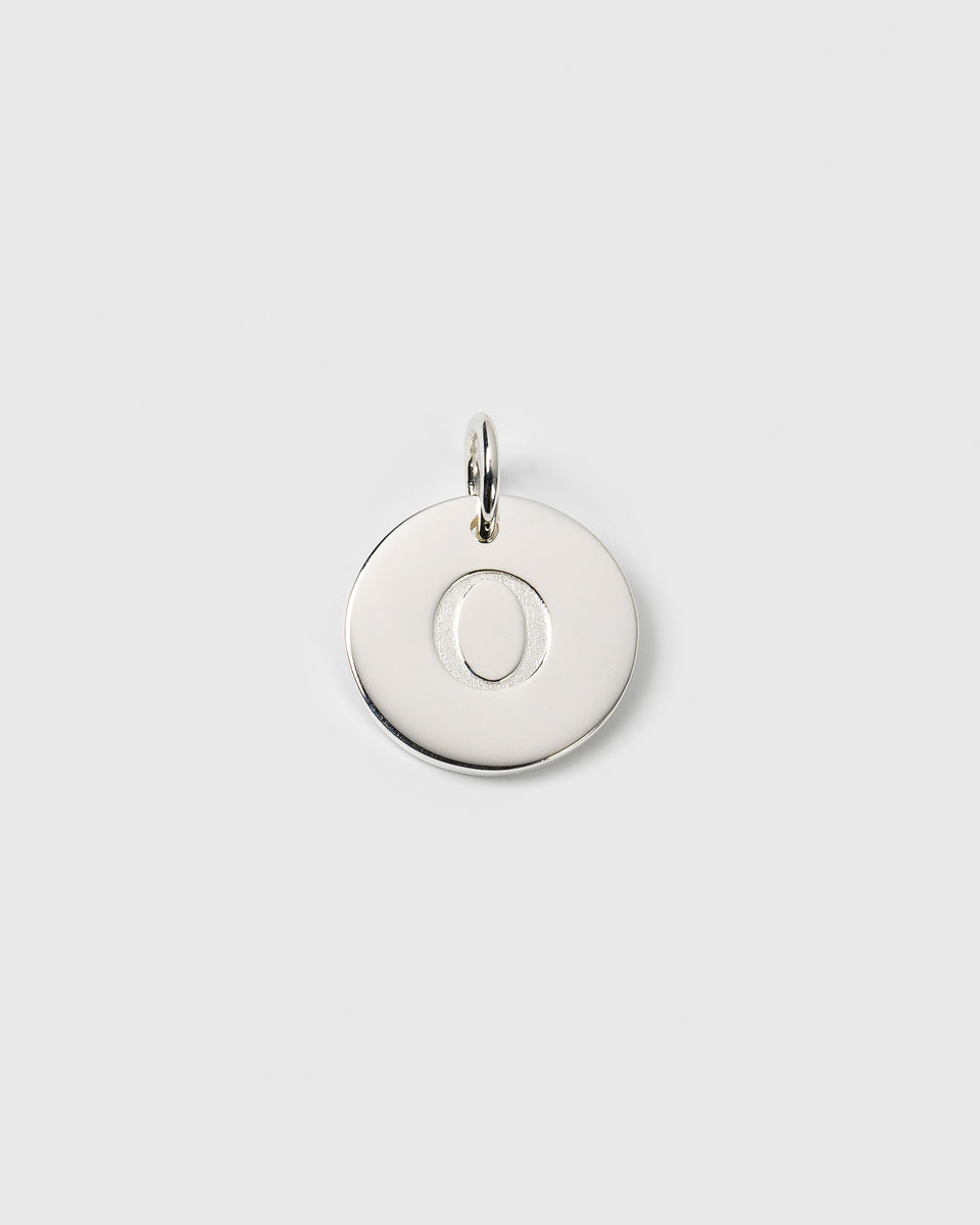 A product shot of the Beloved Big Letter O pendant in silver, featuring a circular charm with the letter engraved in the center.