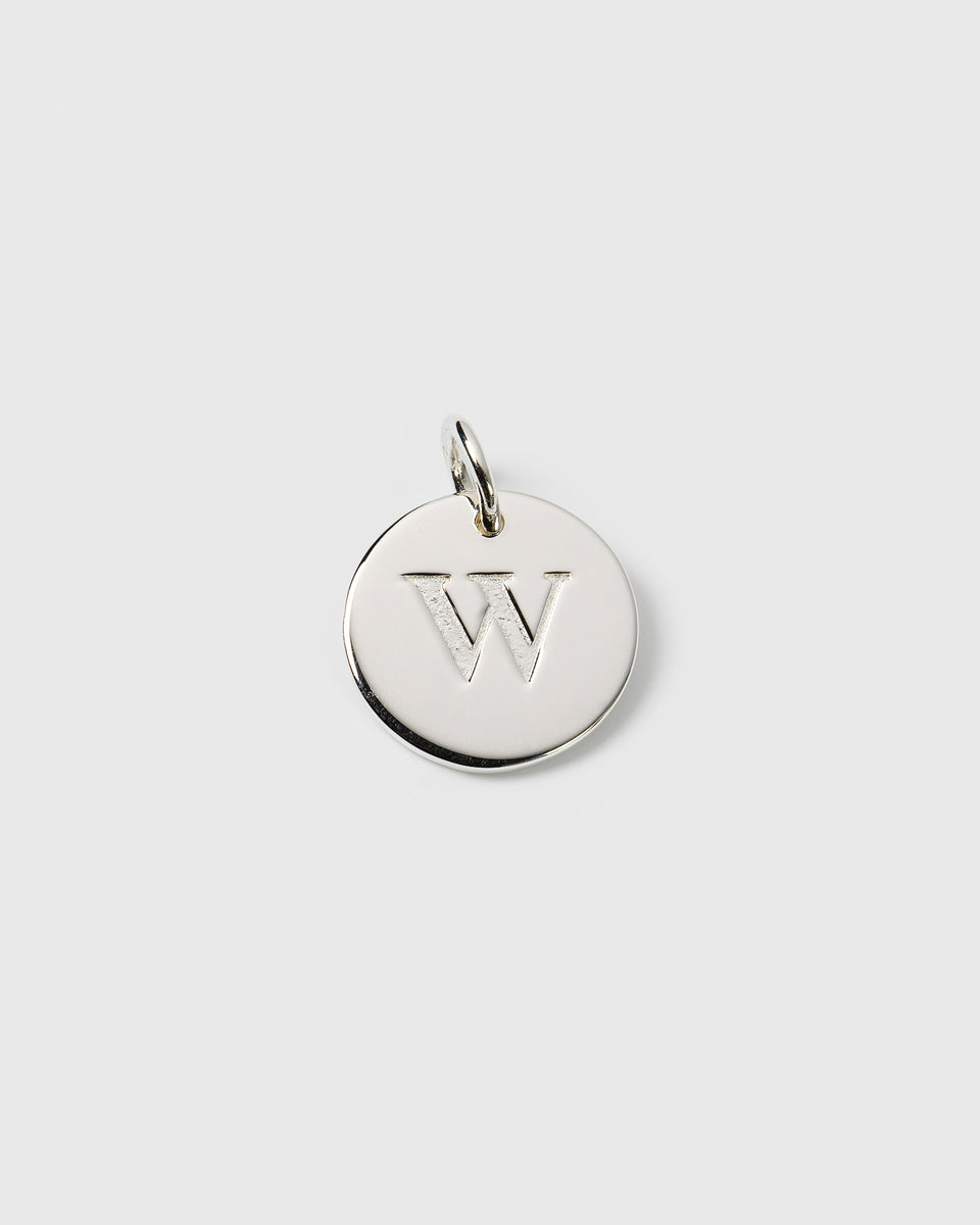A product shot of the Beloved Big Letter Silver pendant, featuring a round charm with the letter 'W' engraved on its surface.