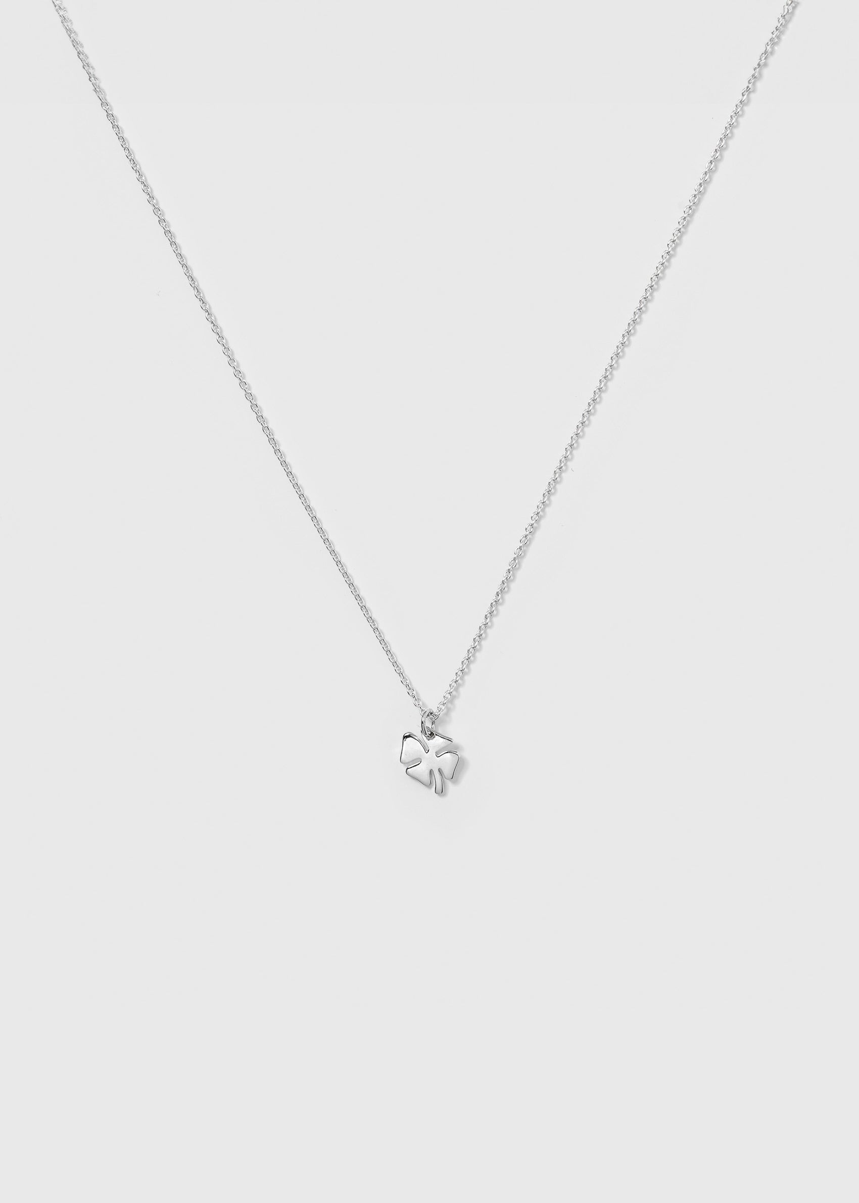 A product shot of the Bring Me Luck Necklace in silver, featuring a fine chain and a small four-leaf clover pendant.