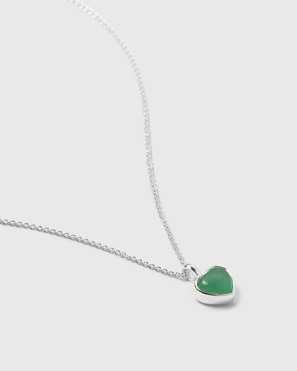 A close-up image of the La La Love Necklace in silver, focusing on the heart-shaped green jade pendant and the delicate silver chain.