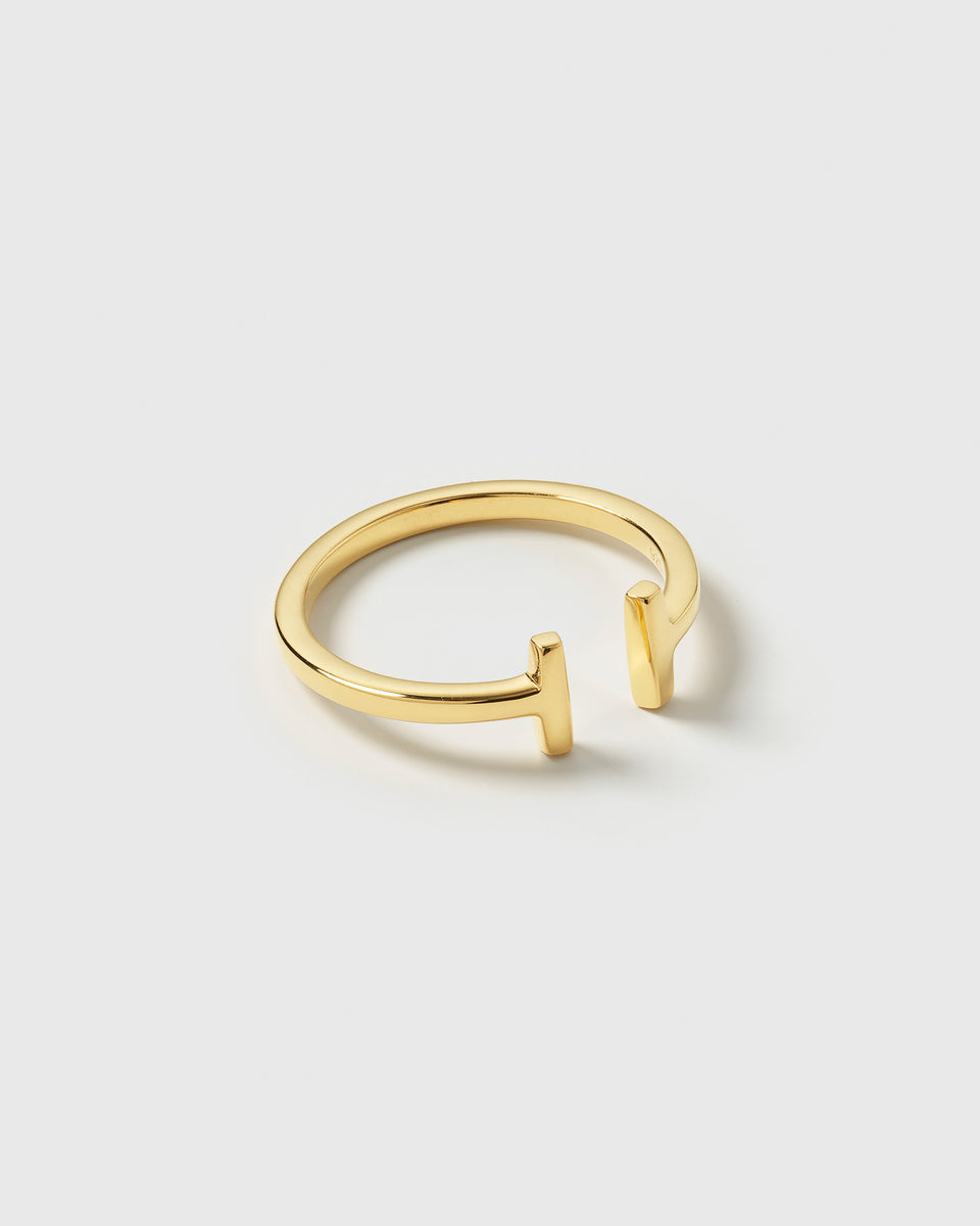 A product shot of the Strict Bar Ring Gold, featuring its open, adjustable design with two vertical bar-shaped ends.