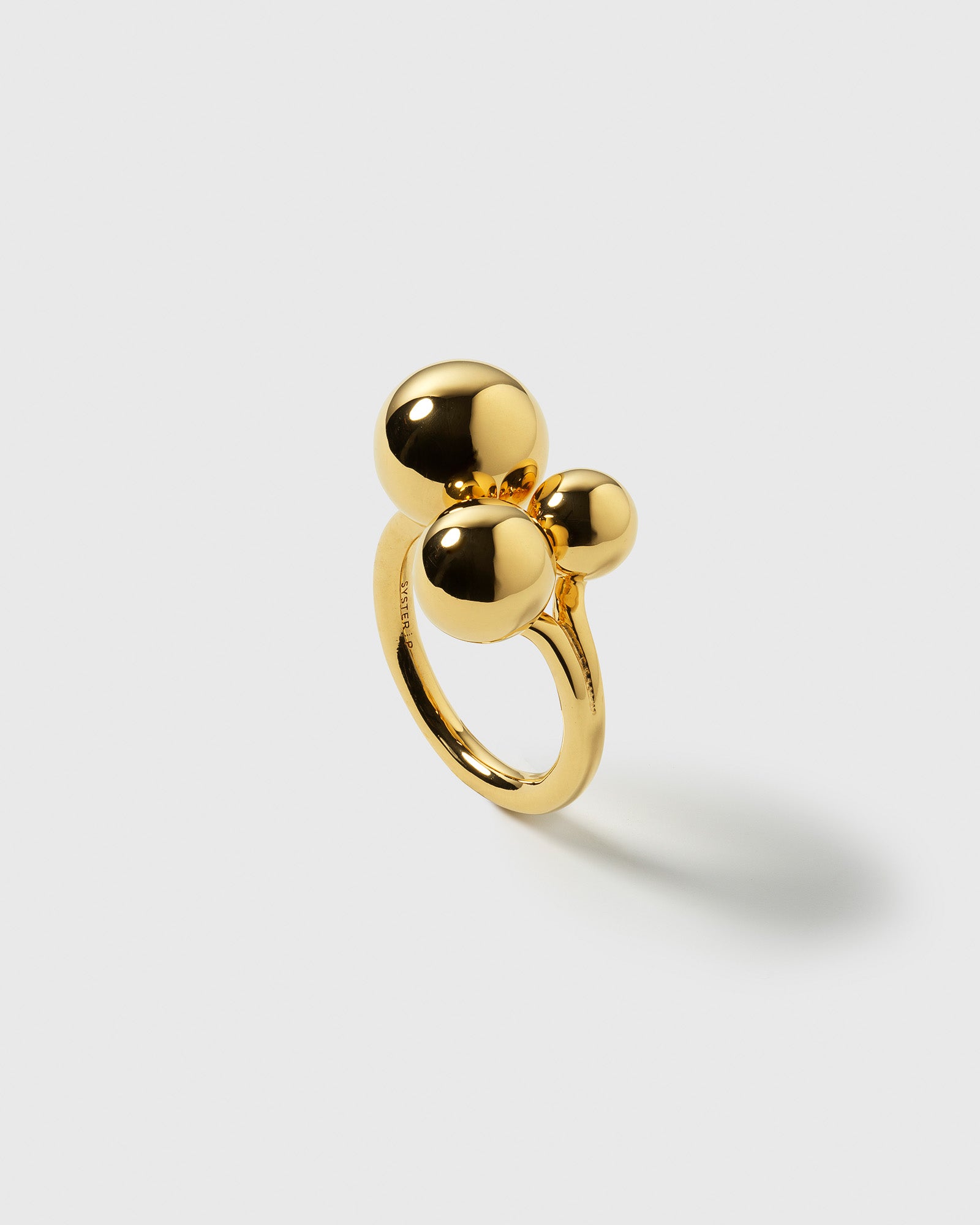 A product shot of the Universe Ring Gold, featuring its bold design of three polished spheres of varying sizes.