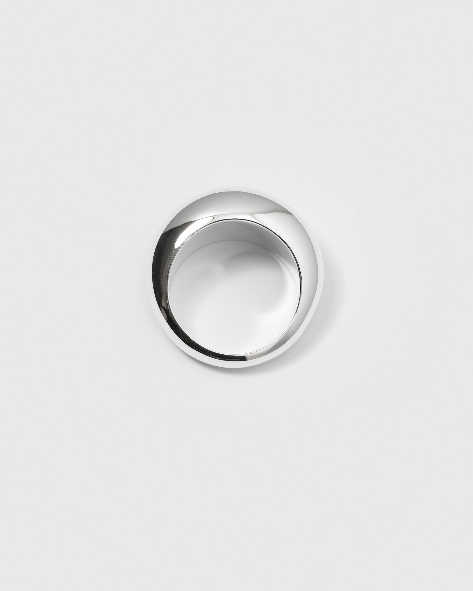 A product shot of the Bolded Big Ring in silver, seen from above to showcase its thick, rounded, and polished design.