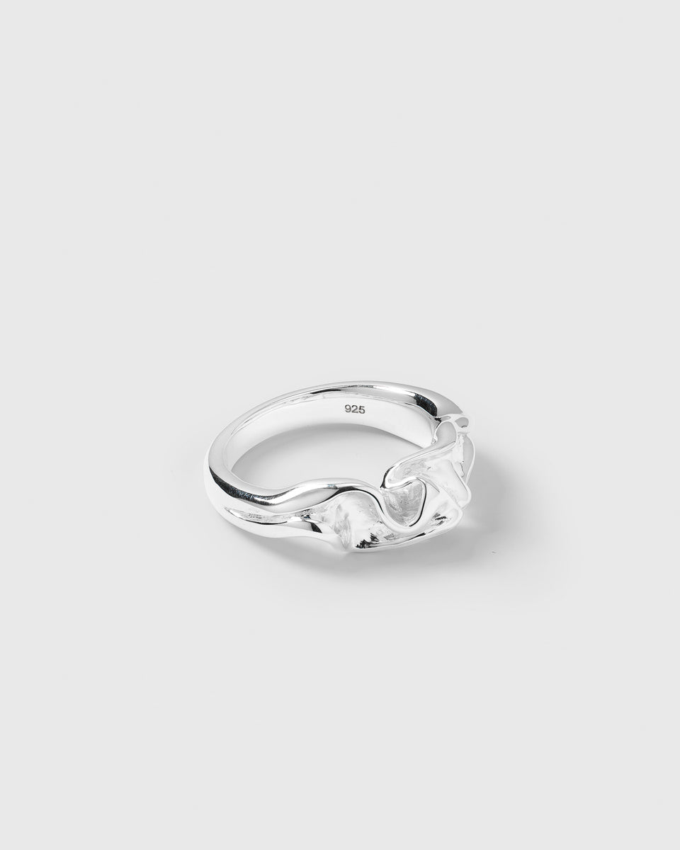 A product shot of the Moulded Narrow Ring Silver, angled to showcase its irregular, nature-inspired design and textured surface.