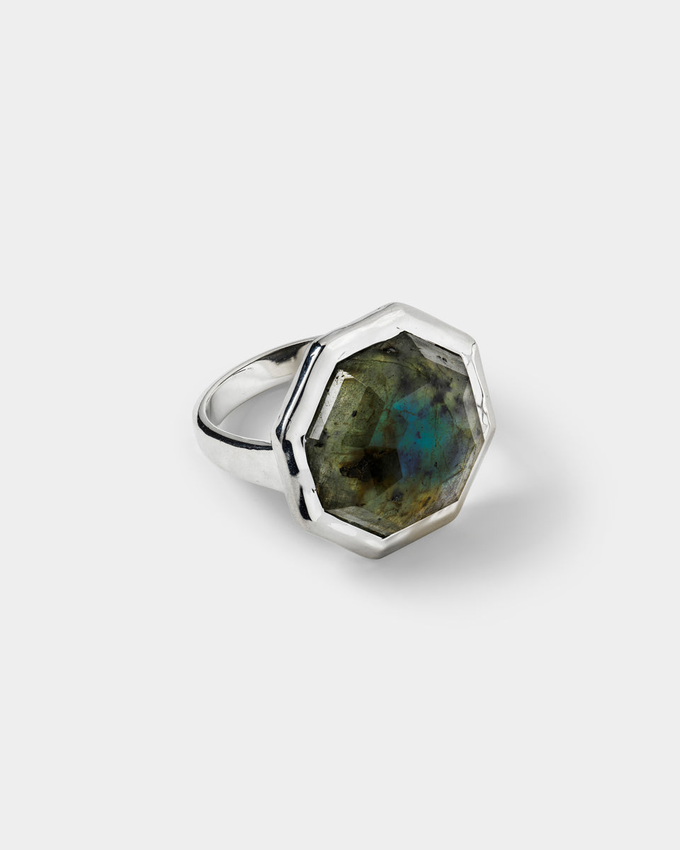 A ring in silver, featuring a large, faceted, octagon-shaped labradorite stone.